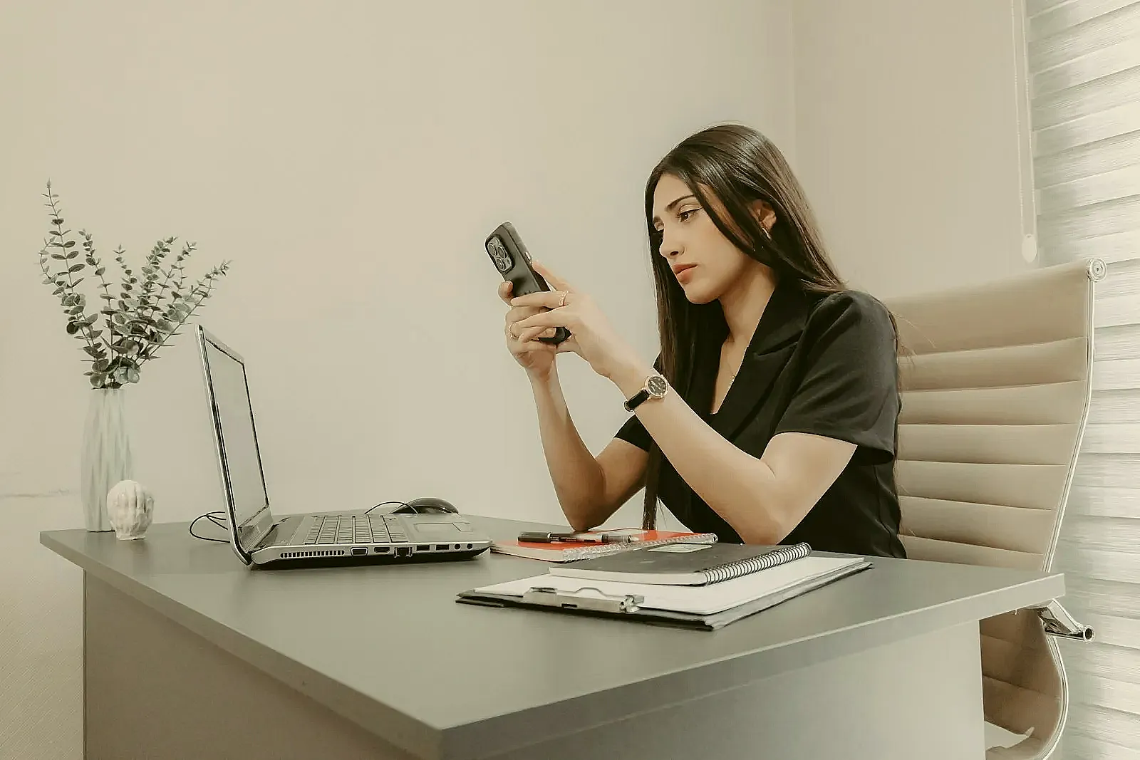 A busy hiring manager quickly reviewing applications at their desk.