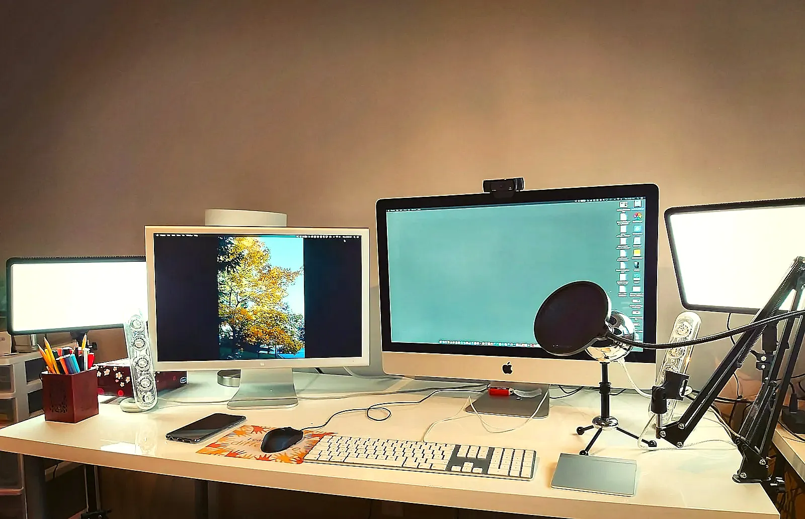 A person editing their resume on a computer with the job posting open on a second monitor.