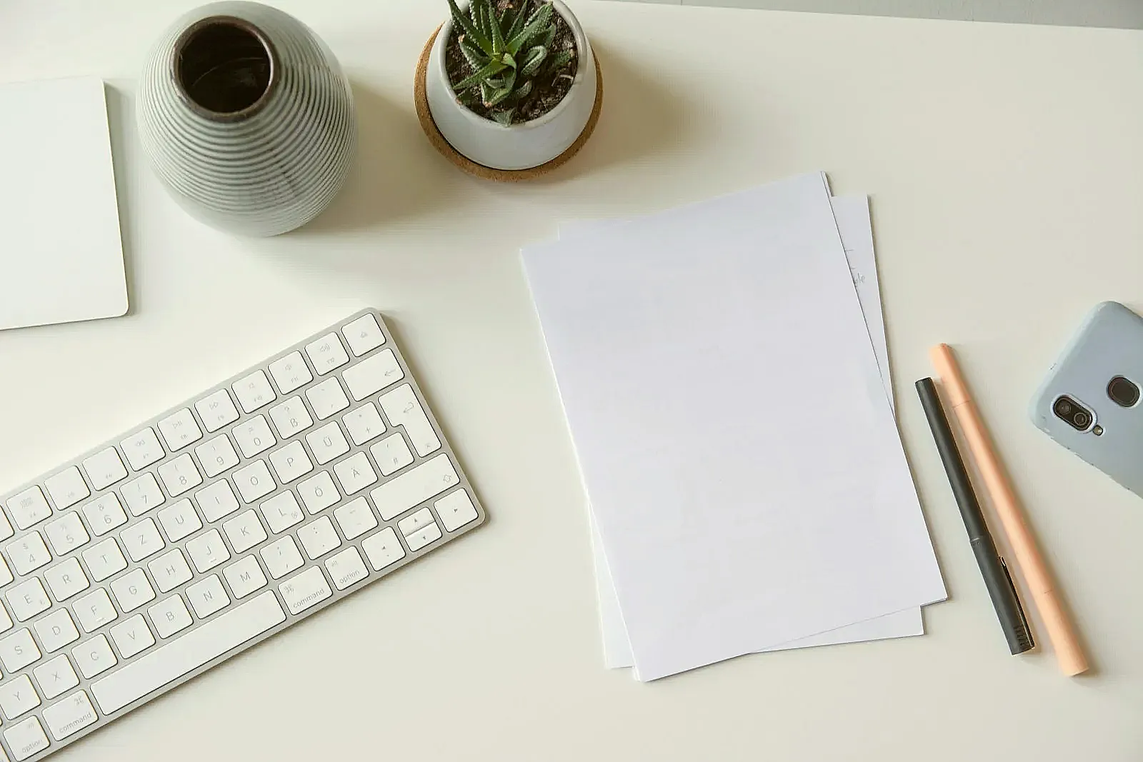 A final resume review on a desk focused on removing clutter before submission.