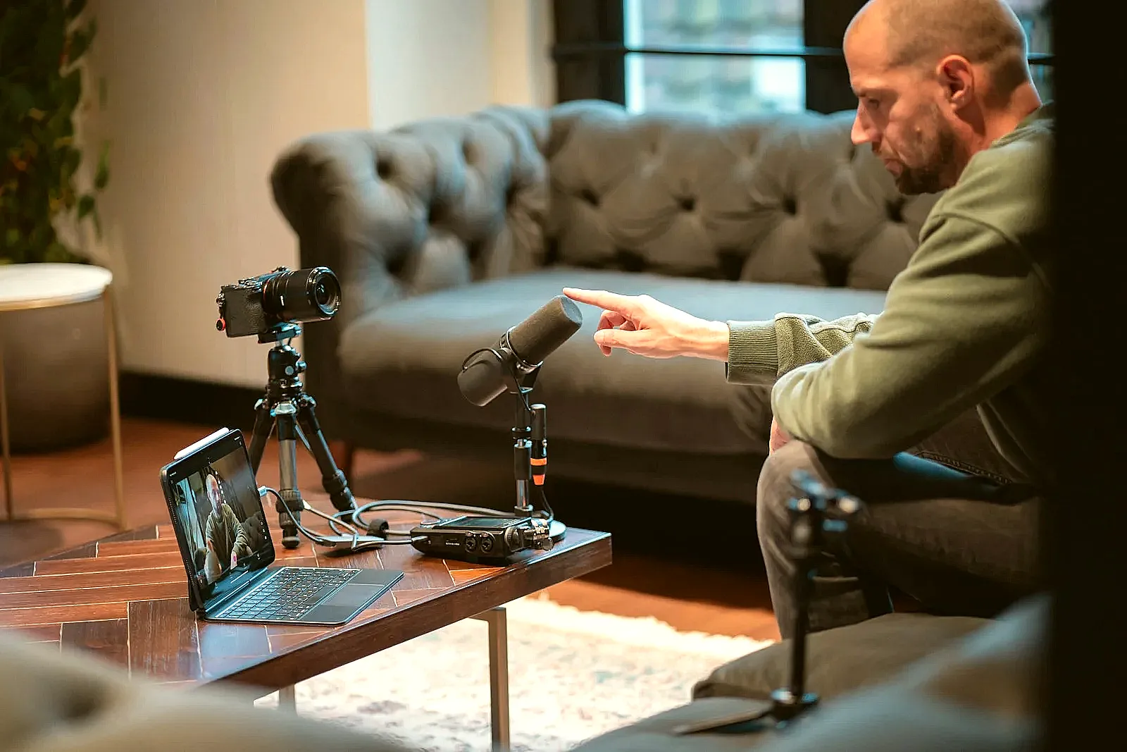 A person practising interview answers at home with notes.