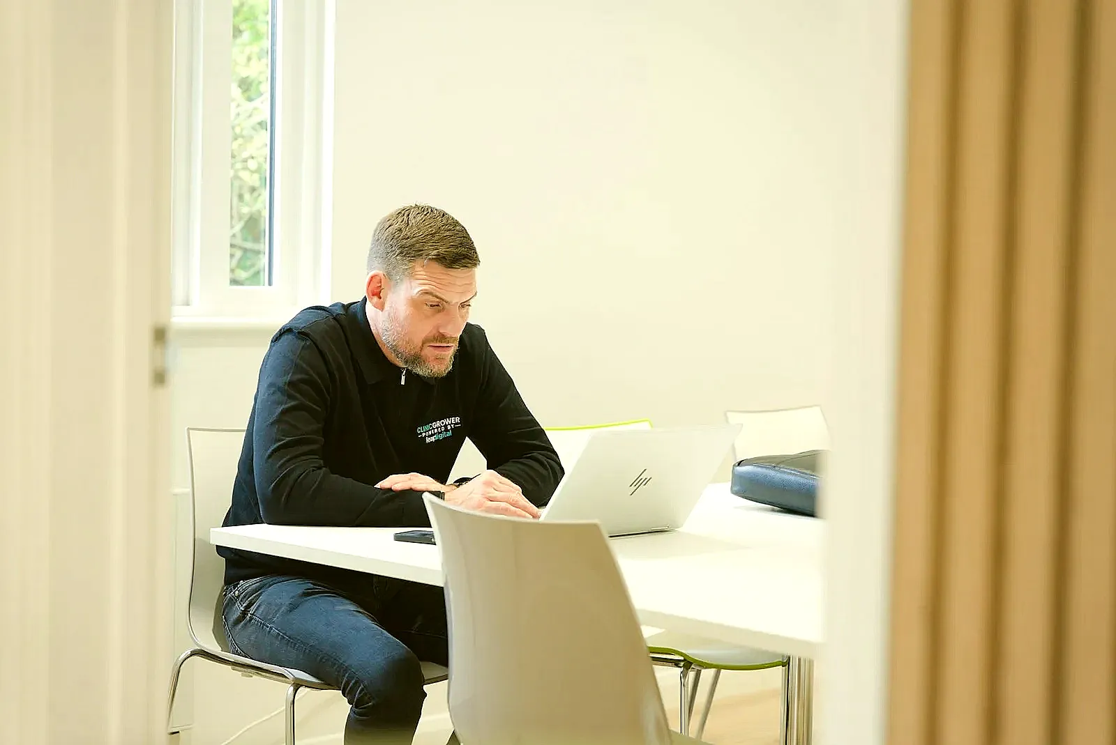 A job seeker researching a company on their laptop before writing a cover letter.